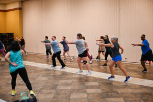 Ladies participate in exercise routine, part of the Ladies Refit exercise program, during the Community Connections program Sept. 4 at the Fort Hood Main Post Chapel. (U.S. Army photo by Derika Upshaw, Fort Hood Public Affairs)