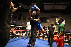 Pvt. Raul Gonzalez, 2nd Battalion, 8th Cavalry Regiment, 1st Armored Brigade Combat Team, 1st Cavalry Division, cheers while being lifted into the air after winning his bout against Spc. Jose Perez, right, who looks on, Regimental Support Squadron, 3rd Cavalry Regiment, during Fight Night: Return 2 The Ring Sept. 12 at Abrams Physical Fitness Center at Fort Hood. (U.S. Army photo by ScottDarling, Fort Hood Public Affairs)