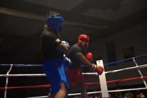Pfc. Vernon Jackson, 1st Battalion, 82nd Field Artillery Regiment, 1st Cavalry Division Artillery, takes a swing at Spc. Zechariah Medina, 2nd Battalion, 5th Cavalry Regiment, 1st Armored Brigade Combat Team, 1st Cavalry Division, during their bout at Fight Night: Return 2 The Ring Sept. 12 at Abrams Physical Fitness Center at Fort Hood. (U.S. Army photo by Ayumi Davis, Fort Hood Public Affairs)