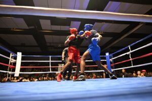 Capt. Tyler Thompson, 4th Battalion, 5th Air Defense ArtilleryRegiment, 69th Air Defense Artillery Brigade, lands a hit on Pvt. Royal Pierson, 1st Battalion, 8th Cavalry Regiment, 2nd Armored Brigade Combat Team, 1st Cavalry Division, in their bout during Fight Night: Return 2 The Ring Sept. 12 at Abrams Physical Fitness Center at Fort Hood. (U.S. Army photo by Scott Darling, Fort Hood Public Affairs)